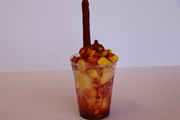 Traditional mangonada frozen dessert with mango chunks, chamoy, and tamarindo stick from Las Michoacanas ice cream shop in Rancho Cordova