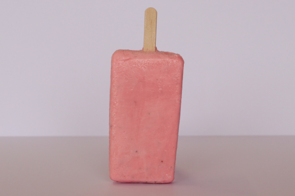 Strawberry paleta de leche, a creamy Mexican-style ice cream bar with fruity flavor and smooth texture