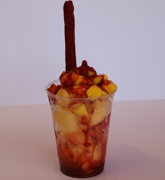 Traditional mangonada frozen dessert with mango chunks, chamoy, and tamarindo stick from Las Michoacanas ice cream shop in Rancho Cordova